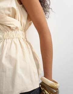 Model wearing Poplin wrap drape detail top in ecru