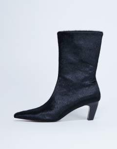 Model wearing Poppy real leather point toe ankle boot in black pony