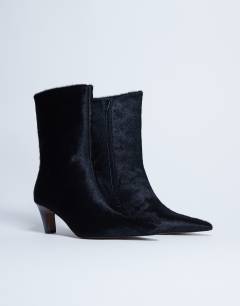 Model wearing Poppy real leather point toe ankle boot in black pony