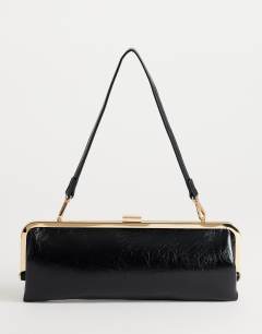 Model wearing Poppy small rectangle clasp shoulder bag in black