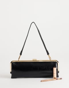 Model wearing Poppy small rectangle clasp shoulder bag in black