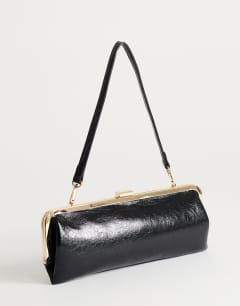 Model wearing Poppy small rectangle clasp shoulder bag in black