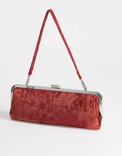 Model wearing Poppy small rectangle clasp shoulder bag in burgundy