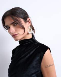 Model wearing Porter pearl stud statement earrings in gold