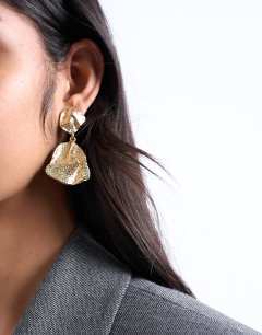 Model wearing Portia drop earrings in gold
