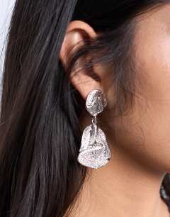 Model wearing Portia drop earrings in silver