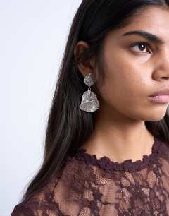Model wearing Portia drop earrings in silver