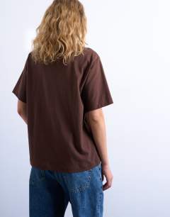 Model wearing Premium basic short sleeve tee in chocolate brown