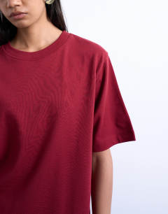 Model wearing Premium basic short sleeve tee in dark red