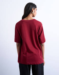 Model wearing Premium basic short sleeve tee in dark red