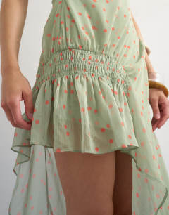 Model wearing Premium chiffon high low maxi dress with smocking detail in green polka dot