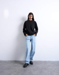 Model wearing Premium clean long sleeve skater tee in black