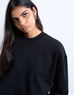 Model wearing Premium clean long sleeve skater tee in black