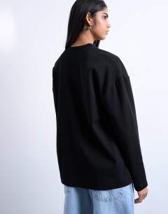 Model wearing Premium clean long sleeve skater tee in black