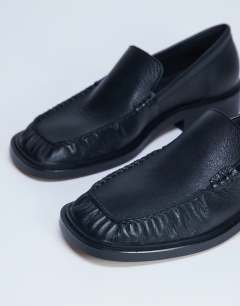Model wearing Premium Clover real leather loafers with ruched detail in black
