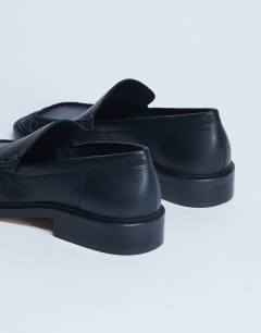 Model wearing Premium Clover real leather loafers with ruched detail in black