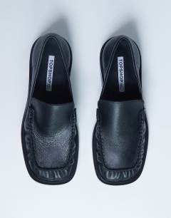 Model wearing Premium Clover real leather loafers with ruched detail in black