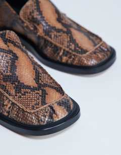 Model wearing Premium Clover real leather loafers with ruched detail in snake print