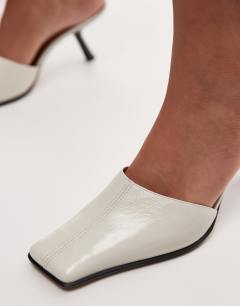 Model wearing Premium Dante leather square toe heeled mule in off white