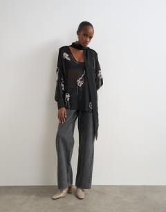 Model wearing Premium embellished chiffon scarf detail top in black