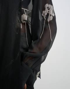 Model wearing Premium embellished chiffon scarf detail top in black