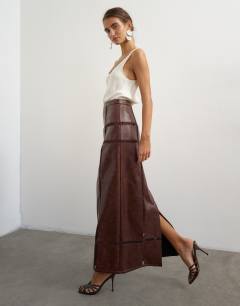 Model wearing Premium faux leather cutwork detail column maxi skirt in chocolate