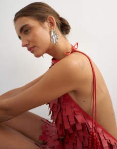 Model wearing Premium faux leather fringed mini dress in red