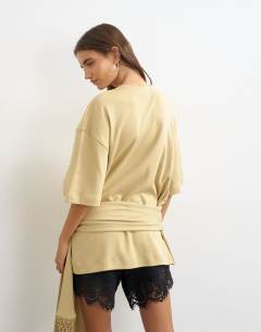 Model wearing Premium fringe tie detail tee in stone