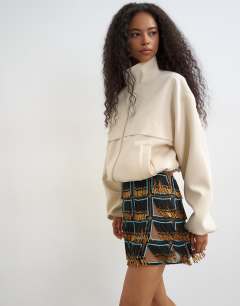 Model wearing Premium heavily embellished fringed mini skirt in blue an black