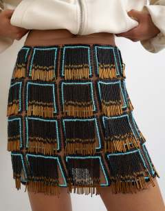 Model wearing Premium heavily embellished fringed mini skirt in blue an black