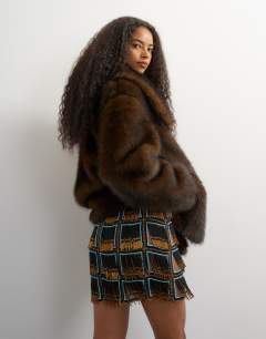 Model wearing Premium heavily embellished fringed mini skirt in blue and black