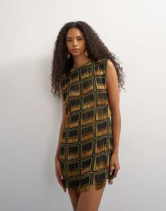 Model wearing Premium heavily embellished open back mini dress in black and gold