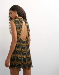 Model wearing Premium heavily embellished open back mini dress in black and gold
