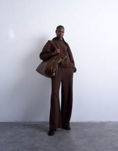 Model wearing Premium heavyweight hoodie in chocolate brown