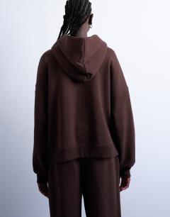 Model wearing Premium heavyweight hoodie in chocolate brown