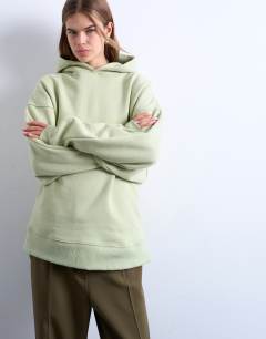 Model wearing Premium heavyweight oversized hoodie in light green