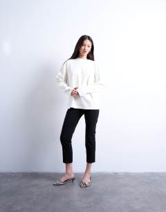 Model wearing Premium interlock long sleeve skater tee in white