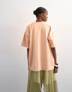 Model wearing Premium interlock oversized tee in peach