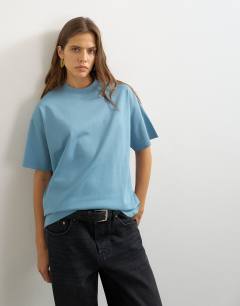 Model wearing Premium interlock t-shirt in blue