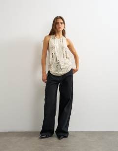 Model wearing Premium low scoop open back tank top with heavy silver embellishment in off white