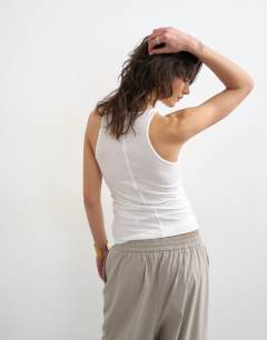 Model wearing Premium lyocell blend soft rib racer vest in white