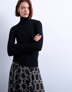 Model wearing Premium rib funnel neck top in black