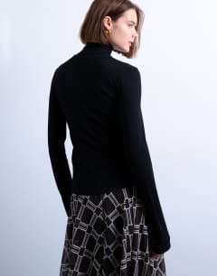 Model wearing Premium rib funnel neck top in black