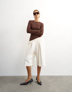 Model wearing Premium rib ruched asymmetric hem long sleeve top in chocolate