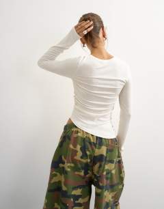 Model wearing Premium rib ruched asymmetric hem long sleeve top in white