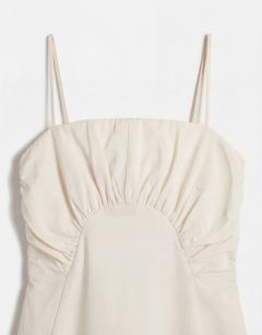 Model wearing Premium ruched bust midi dress in cream