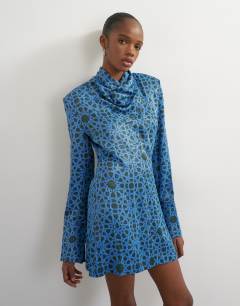 Model wearing Premium satin collapsed funnel shoulder pad mini dress in blue geo print
