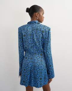 Model wearing Premium satin collapsed funnel shoulder pad mini dress in blue geo print