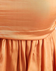 Model wearing Premium satin dropped waist bandeau maxi dress in orange