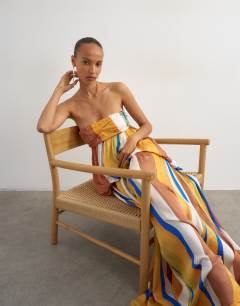 Model wearing Premium satin dropped waist bandeau maxi dress in stripe